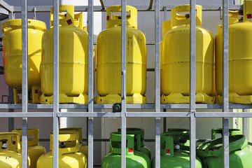 Butane and propane gaz cylinders in a rack