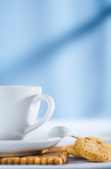 cup with spoon and cookies