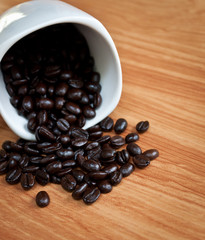 coffee beans with white coffee cup .