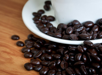 coffee beans with white coffee cup .