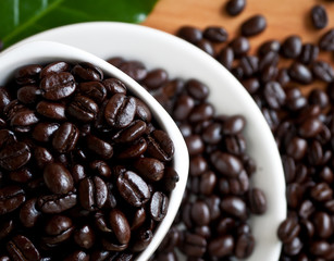 coffee beans with white coffee cup .