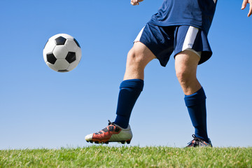 Soccer Player Kicking the ball - low angle