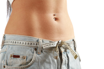 A young woman measuring her waist