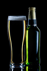 Closed bottle of beer  with glass