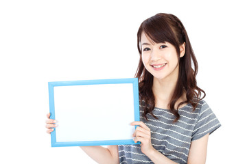 Beautiful young woman with message board