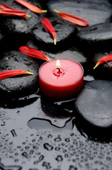 Spa concept- Spa Stones and red flower petals with red candle