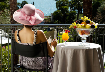 portrait of beautiful woman on the terrace of prestigious hotel