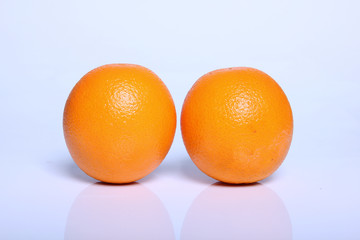 two fresh orange fruit in white