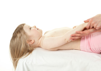 Obraz na płótnie Canvas Massaging lying child