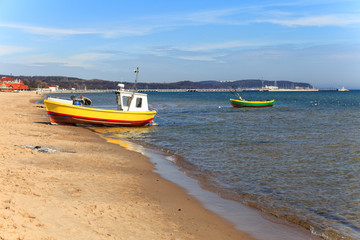 Fishing boats on the background of the pier in Sopot, Poland.