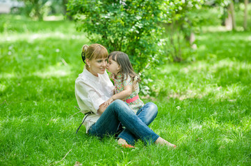 Fototapeta premium Smiling mother and little daughter on nature
