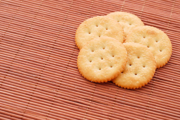 stack of crackers on brown bamboo mat