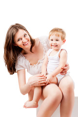 Smiling mother and child, isolated on white