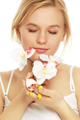 Closeup of a beautiful woman holding a flower