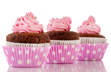 Three Chocolate cupcakes with pink butter icing