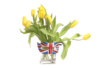 Yellow tulips in a vase with british mask