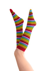 female legs in colorful striped socks isolated on white