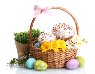 Beautiful Easter cakes, colorful eggs in basket and flowers