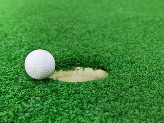 Golf ball near the hole