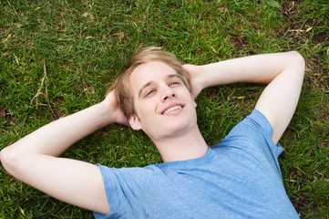 young male lying in the grass