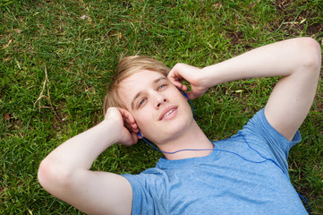 young male lying in the grass