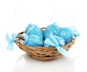 Colorful easter eggs in basket isolated on white