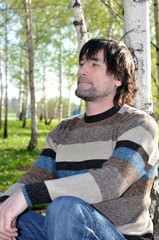 Fototapeta premium Middle-aged man in a birch grove