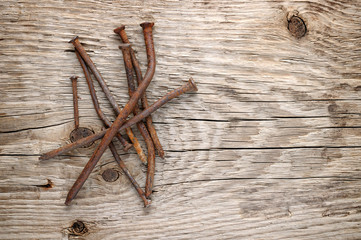 Old rusty nails on wood background