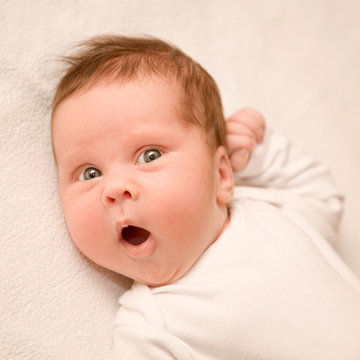 surprised newborn baby with open mouth