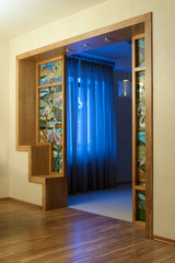 house interior with a stained-glass window and a wooden arch