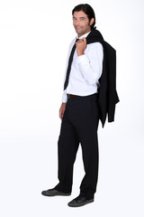 Handsome man with his suit jacket flung over his shoulder