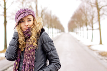 Fototapeta na wymiar young woman outside in winter in snow cold