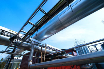 Industrial zone, Steel pipelines and valves against blue sky