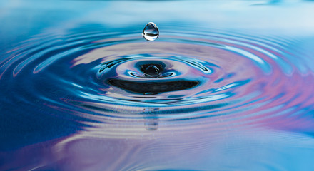 Drop of pure fresh water falls in water