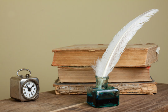 Quill And Inkwell, Old Books, Vintage Clock On A Table