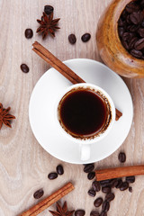 black arabic coffee in small white cup with mortar and pestle