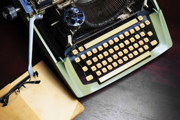 Old typewriter and old book on the table.