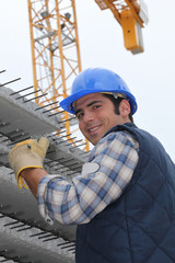 Fototapeta premium Construction worker with slabs of reinforced concrete