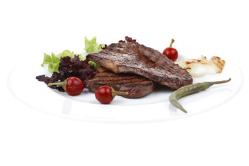 two grilled steak with chili and red peppers