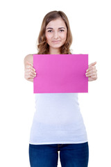 Beautiful girl with a pink sheet of paper winks