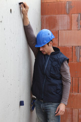 Builder with a plumb line