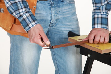 closeup of carpenter working on workbench
