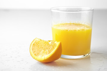 Fresh orange juice and slice of orange isolated on white