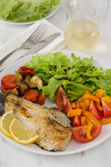 fried fish with vegetables and salad