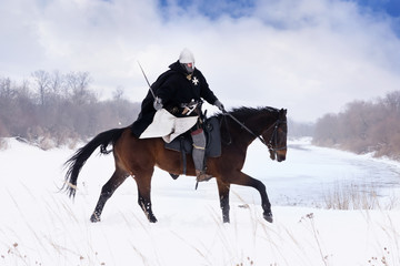 Medieval knight of St. John (Hospitallers) on a horse