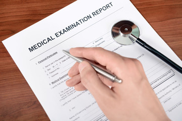 Doctor fills out a medical examination form