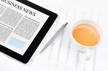 Modern working place with business news on digital tablet