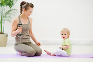 Healthy mother and baby spending time doing fitness