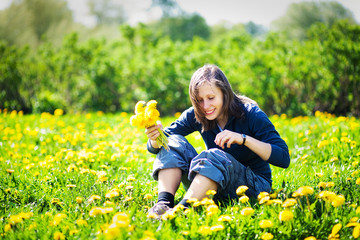 Girl with bunch of dandelions