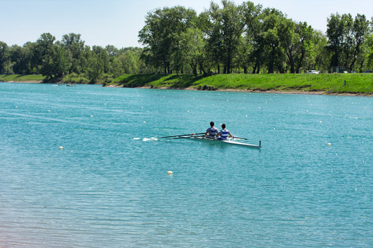 Two young men rowing on lake Jarun, Croatia